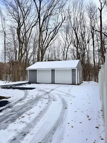 a view of a house with a yard covered in snow