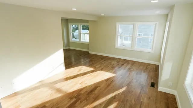 a view of an empty room and wooden floor