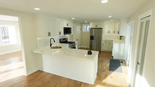 a kitchen with stainless steel appliances a refrigerator and a sink