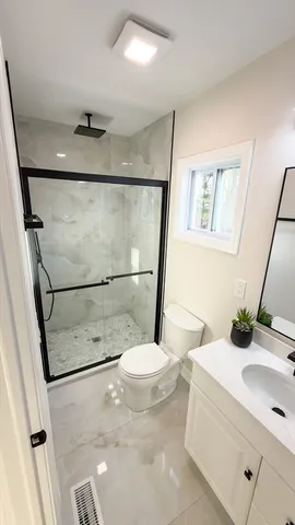 a bathroom with a sink a mirror and a shower