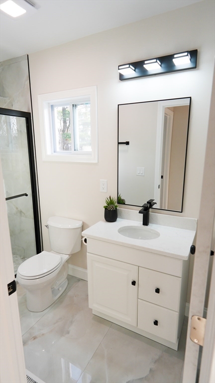 122 Copperfield Road Worcester, MA 01602 - Photo 10 of 28 a bathroom with a sink a toilet and mirror