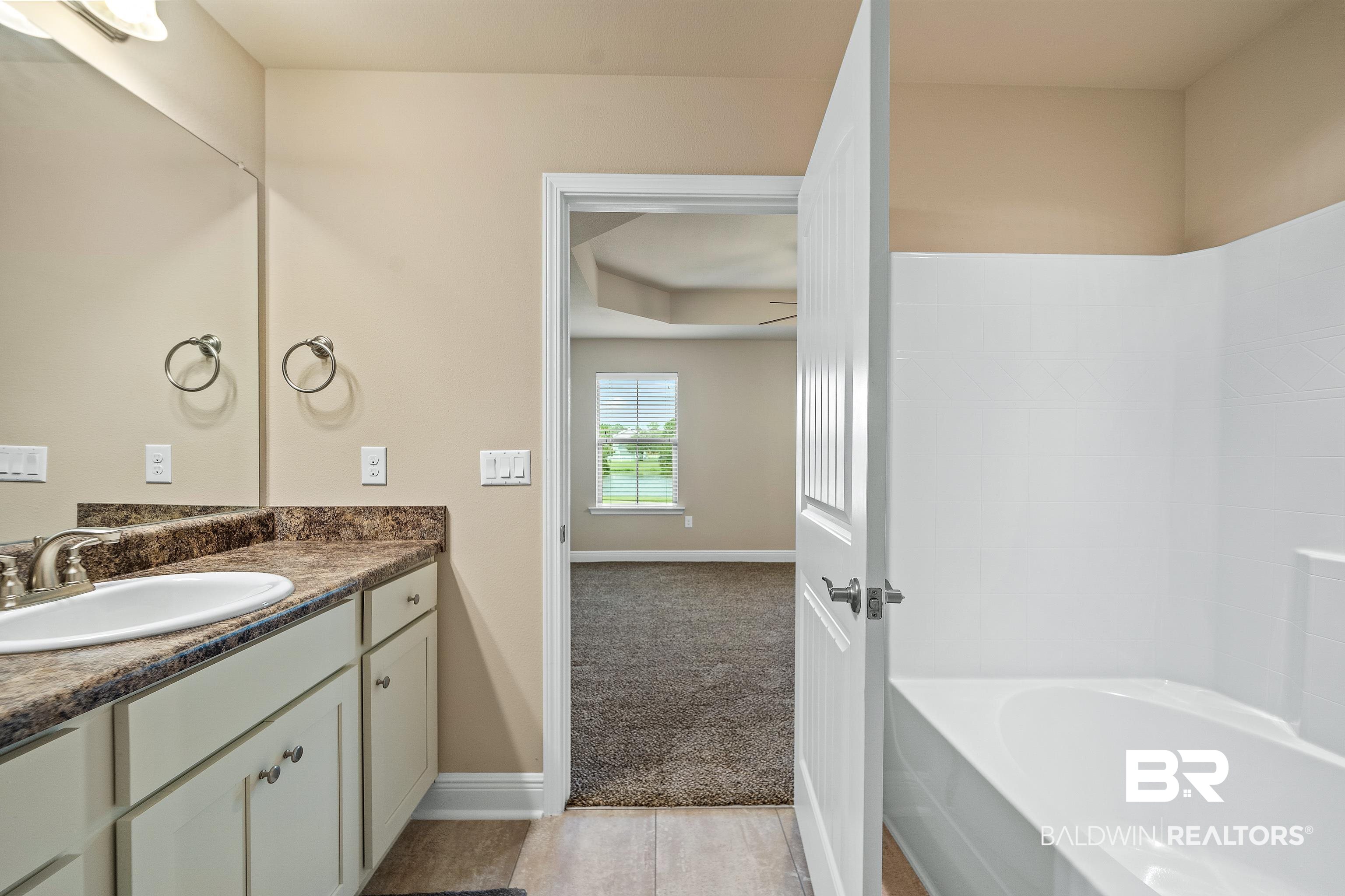 22631 Lake South Drive Foley, AL 36535 - Photo 14 of 25 Bathroom with a tub to relax in and vanity