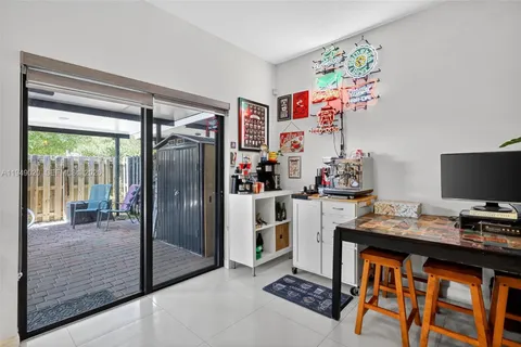 a kitchen with sink a microwave and cabinets