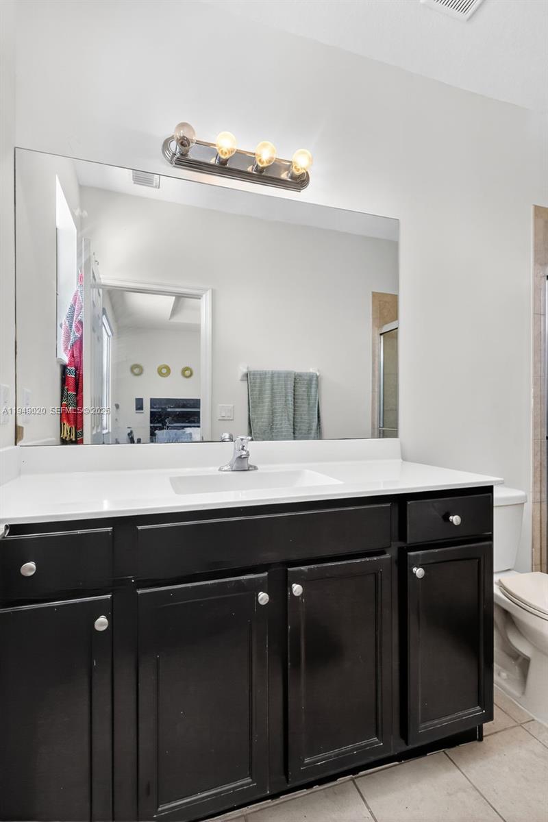11418 Southwest 250th Street Homestead, FL 33032 - Photo 20 of 57 a bathroom with a double vanity sink and a mirror