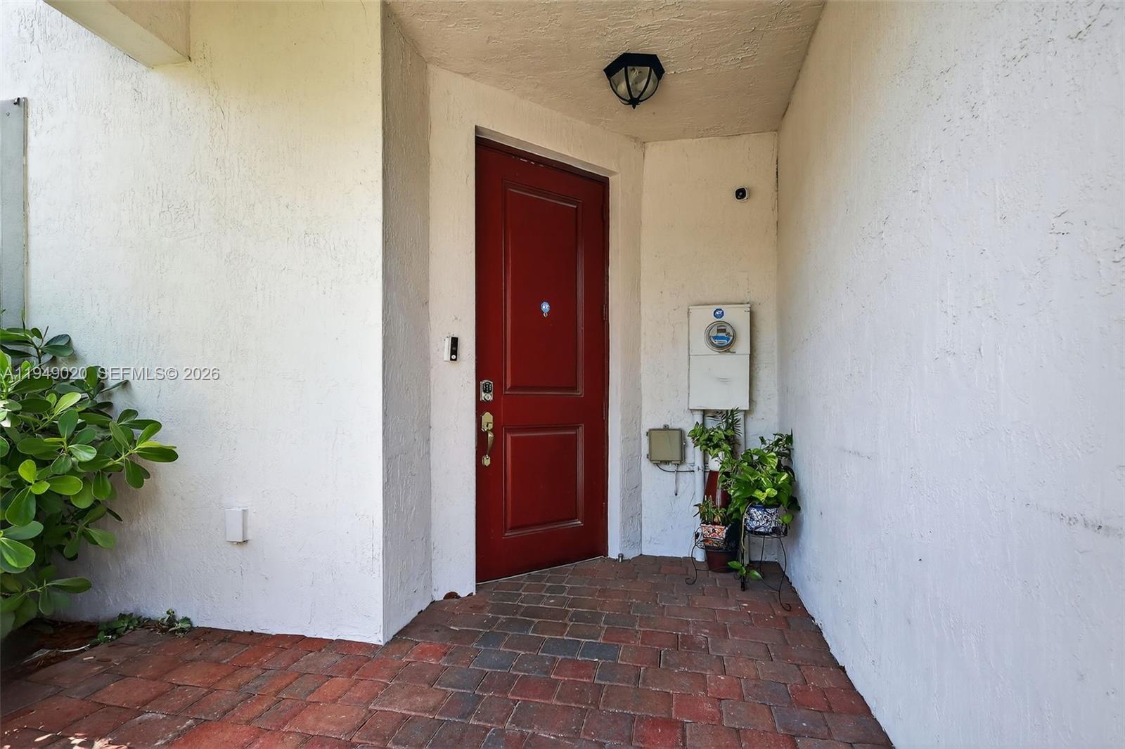 11418 Southwest 250th Street Homestead, FL 33032 - Photo 3 of 57 a view of a hallway with wooden floor and a potted plant