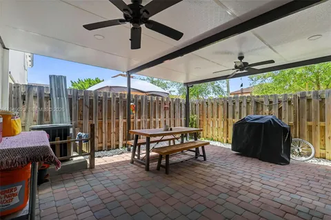 a outdoor space with a table tennis table and chairs