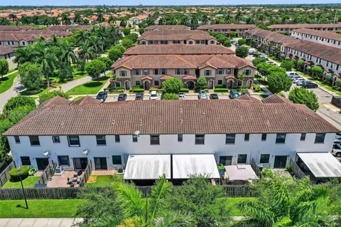 a view of a livingroom with furniture window and kitchen view