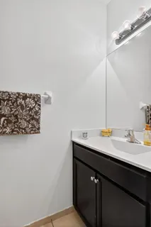 a sink with a vanity and mirror