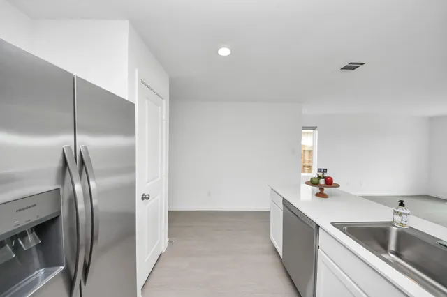 a kitchen with a refrigerator and a sink