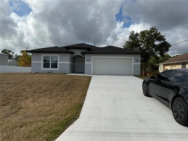 a front view of a house with a garden