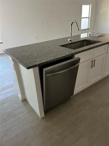 a kitchen with a sink and cabinets