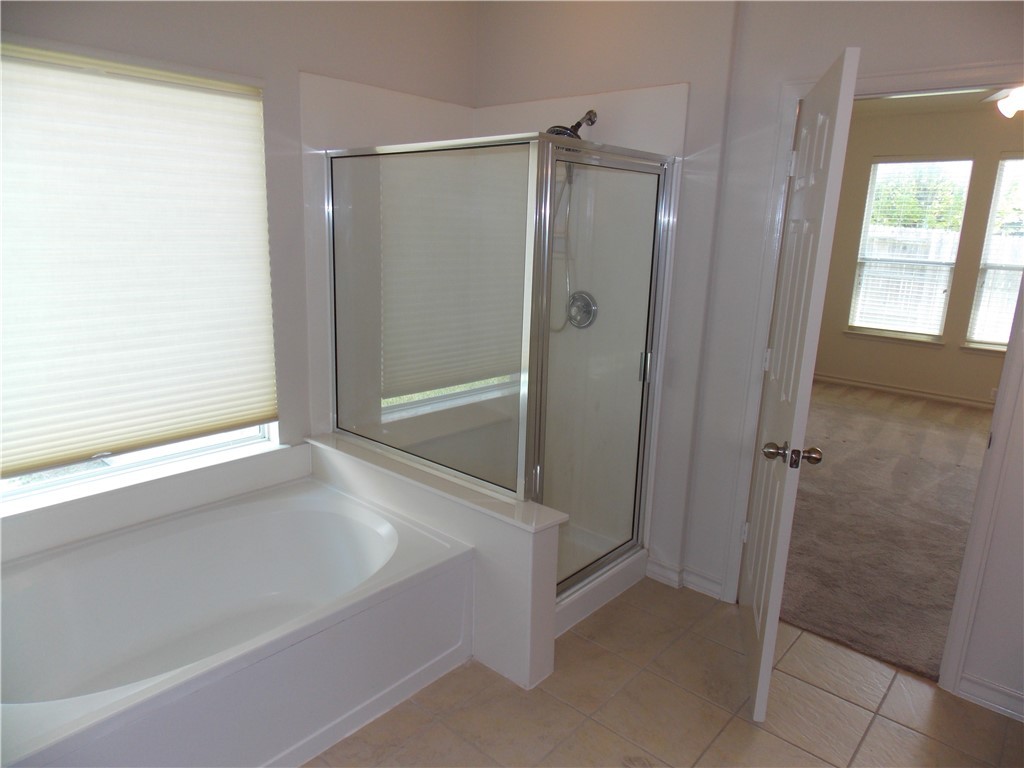 20961 Mandrake Drive Pflugerville, TX 78660 - Photo 26 of 34 a bathroom with a shower and a tub