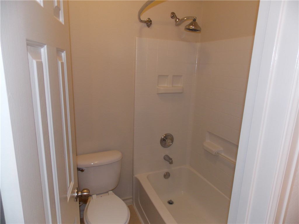 20961 Mandrake Drive Pflugerville, TX 78660 - Photo 10 of 34 a white toilet sitting next to a bath tub