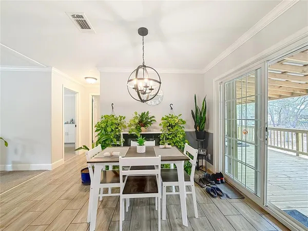 a utility room with dryer washer and a view of living room