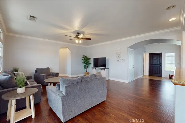 a living room with furniture and a wooden floor
