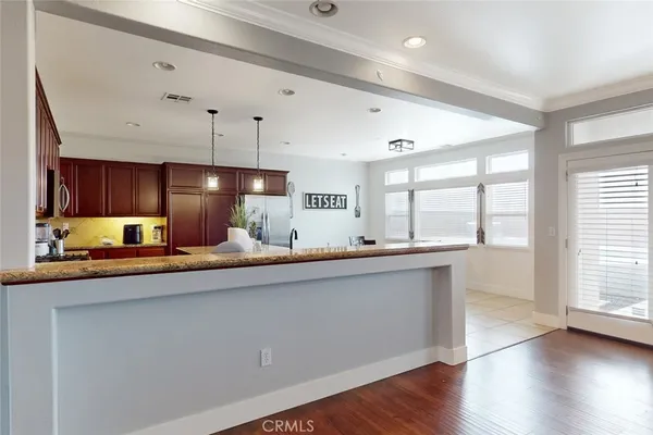 a large kitchen with a large window a sink and stainless steel appliances