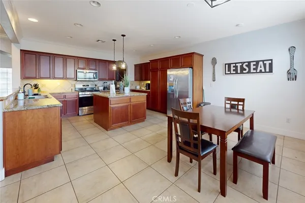 a kitchen with a refrigerator and a dining table