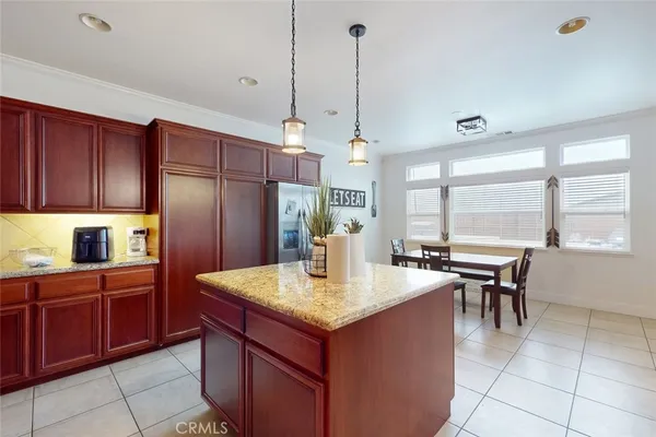 a kitchen with a stove a refrigerator and a center island