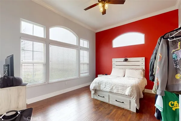 a bedroom with a bed and a large window