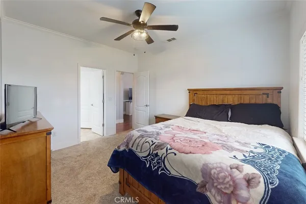 a bedroom with a bed and a chandelier