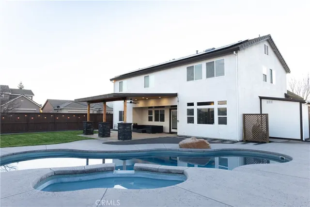 a front view of a house with yard and trees