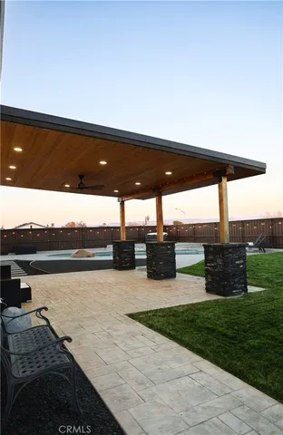 a view of a swimming pool with a patio and a garden