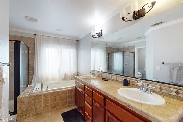 a spacious bathroom with a granite countertop tub sink and mirror
