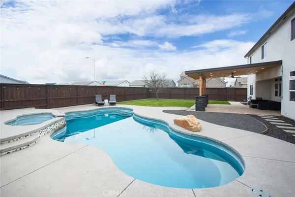 a view of a swimming pool with an outdoor seating