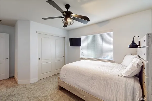 a bedroom with a bed and a large window