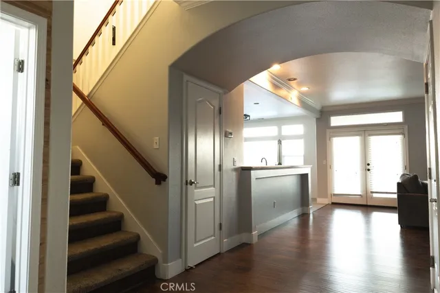 a view of an entryway with wooden floor and door