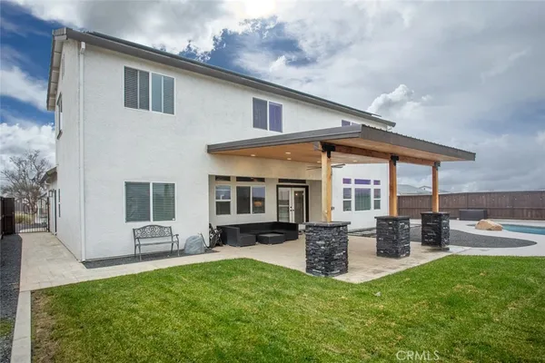 a front view of house with a garden and patio