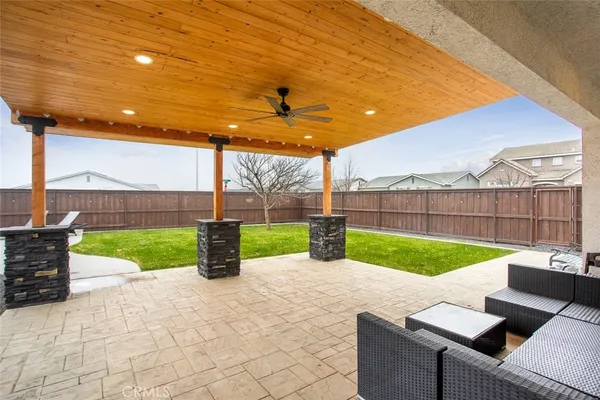 a view of backyard with seating area and green space