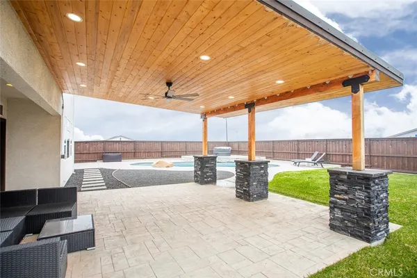 a view of a patio with a table and chairs