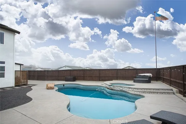 a view of a swimming pool with a yard