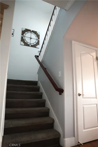 a view of staircase with white walls