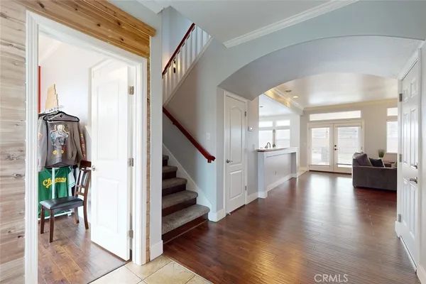 a view of a hallway view with wooden floor and staircase