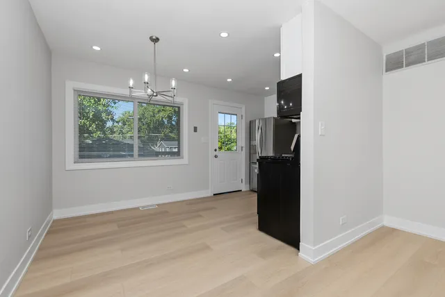 an empty room with windows and closet