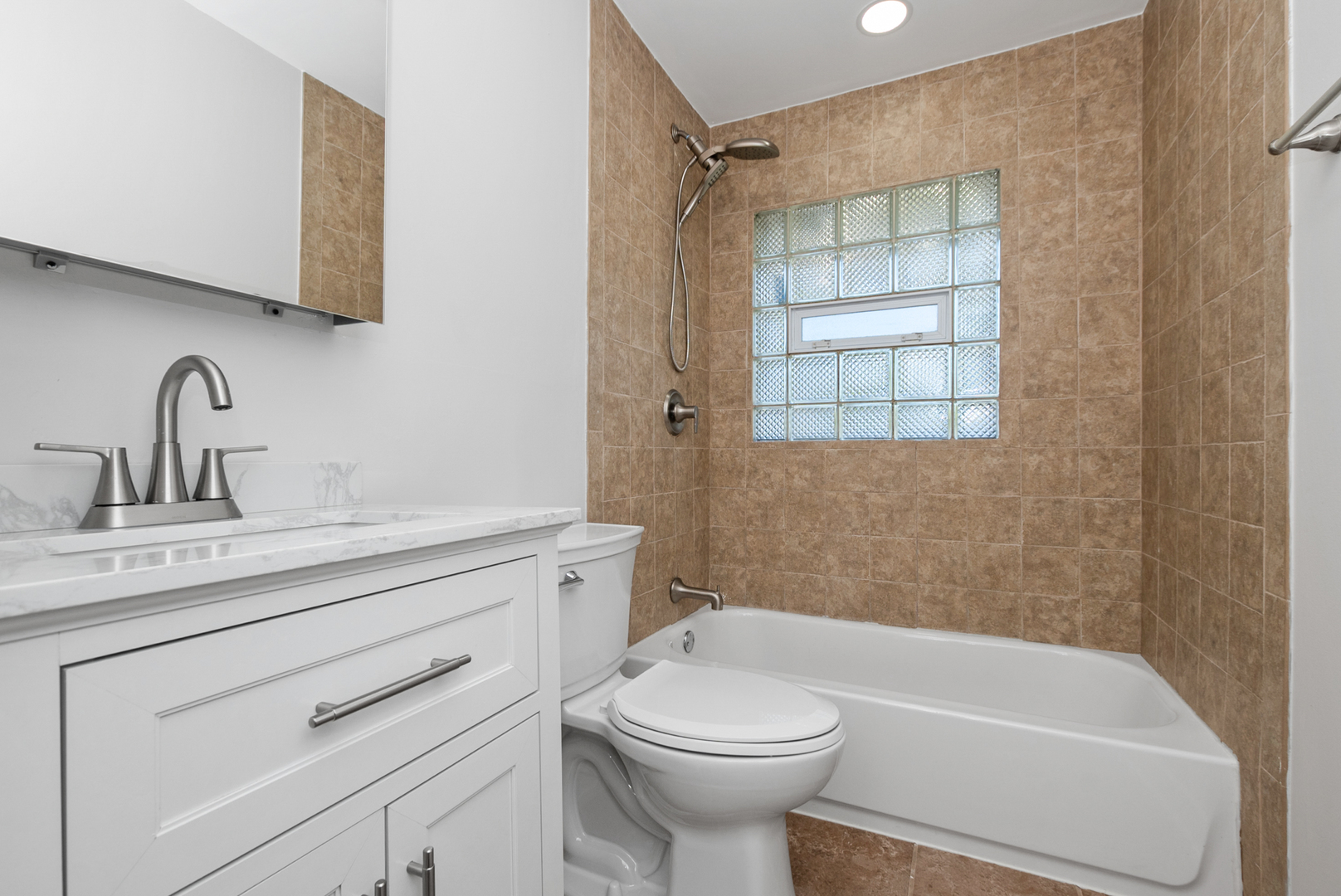 16822 91st Avenue Orland Hills, IL 60487 - Photo 10 of 21 a bathroom with a sink a toilet and shower