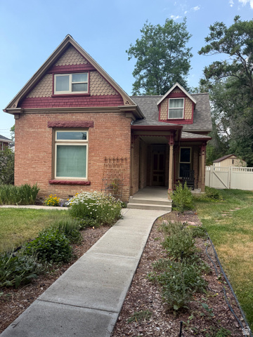 541 300 North Provo, UT 84606 - Photo 3 of 36 Brick exterior featuring a covered porch, decorative gable shingles, and a dormer window