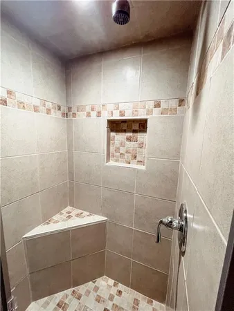 a bathroom with a bathtub and shower