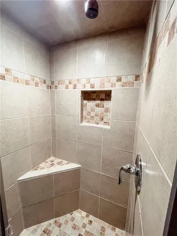 a bathroom with a bathtub and shower