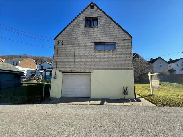 a front view of a house with parking