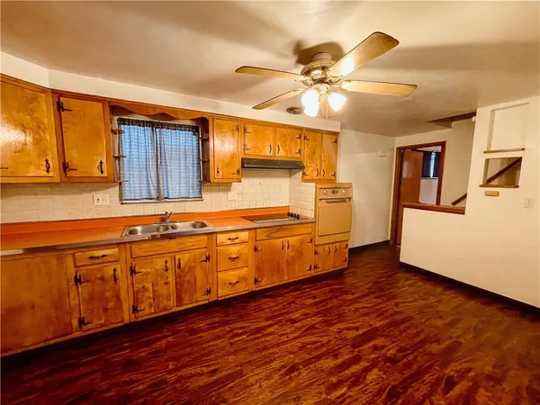 a kitchen with sink and cabinets