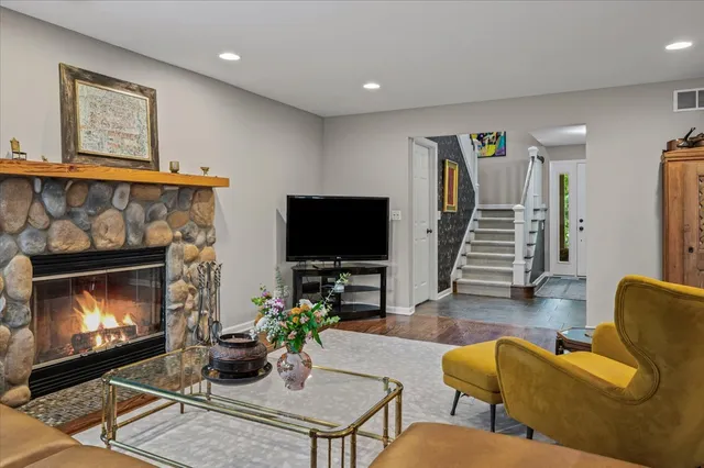 a living room with furniture a flat screen tv and a fireplace