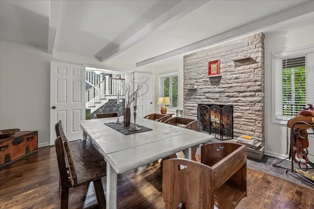 a view of a dining room with furniture and a fireplace