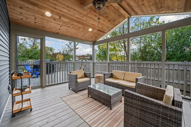 a outdoor living space with patio furniture and wooden floor