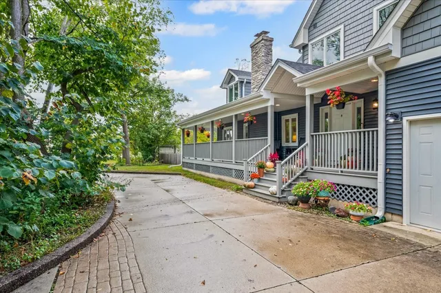 a view of a house with a small yard and potted plants
