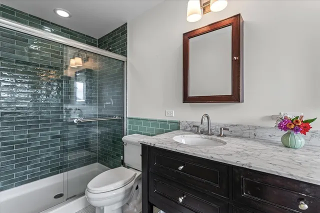 a bathroom with a toilet a sink and mirror