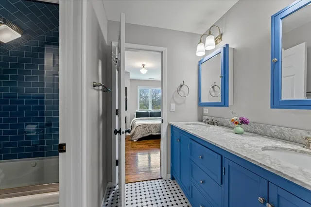 a spacious bathroom with a granite countertop sink mirror and shower