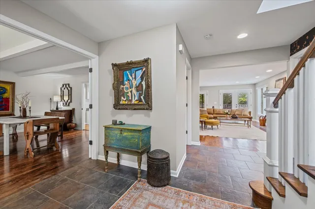 a living room with furniture and a baby crib